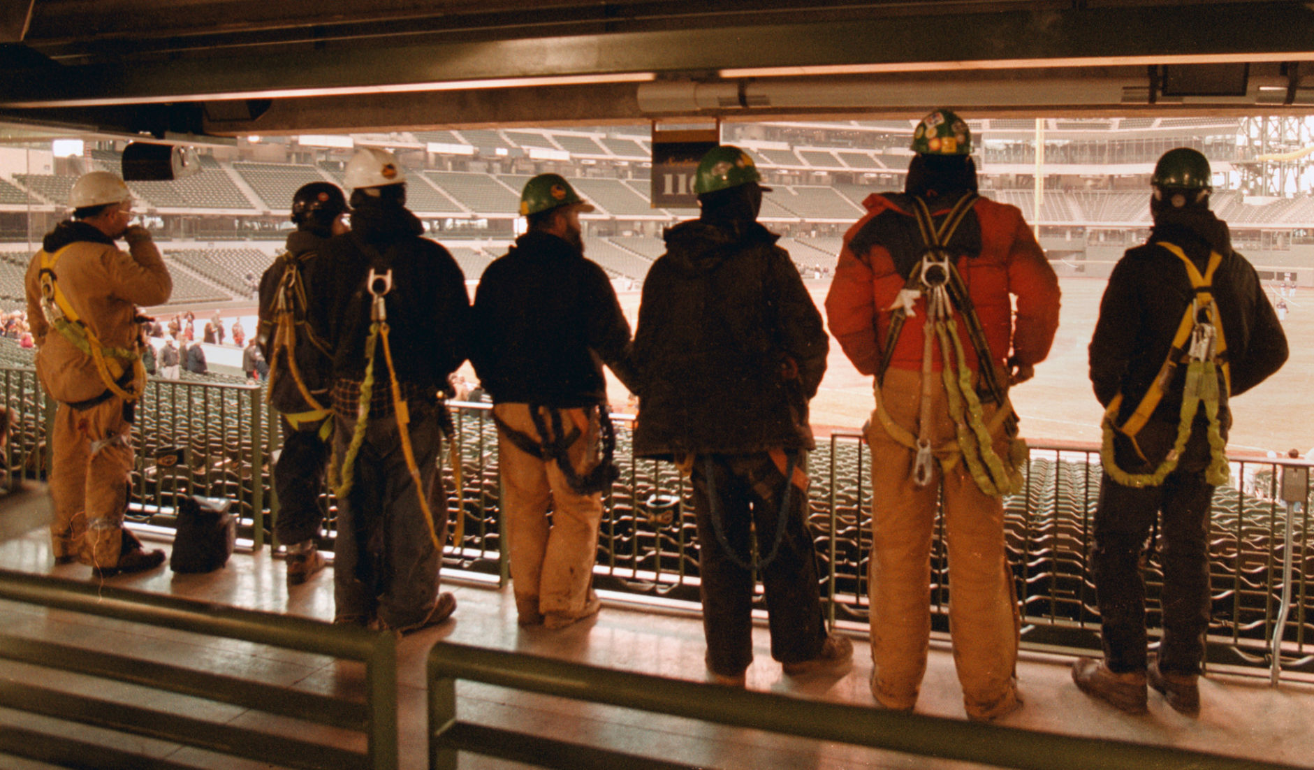 Workers watch players on new field